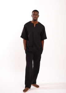 black man in black linen tee and linen pants