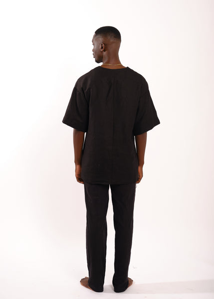 black man in black linen tee and linen pants
